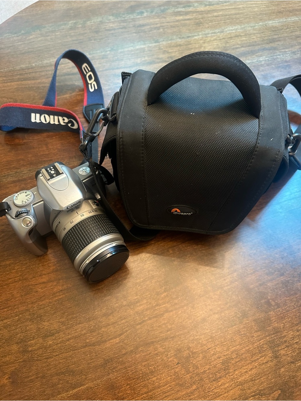 Canon Silver EOS Rebel T1 Camera with Black Compact Lowepro Bag and Canon Strap